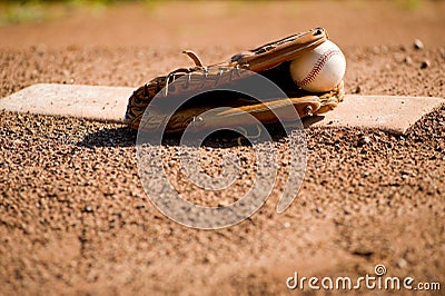 Baseball Glove and Ball on Pitcher s Mound