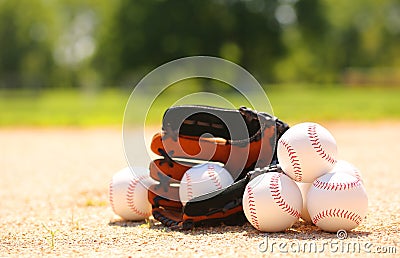 Baseballs and Glove on Field