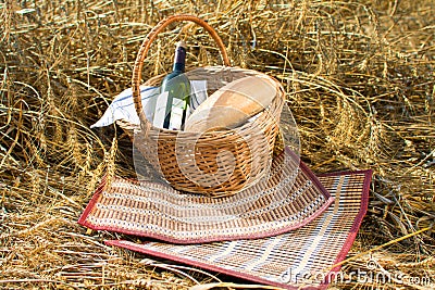 Basket with bread, food and wine bottle