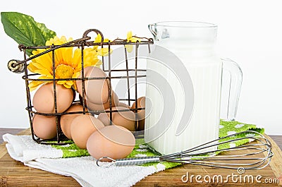 Basket of brown eggs and pitcher of milk
