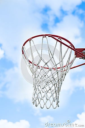 Basketball goal with blue sky and clouds