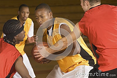 Basketball Player With Ball Being Blocked By Opponents