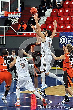 Basketball player with a ball flies to the basket