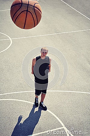 Basketball player at the court shooting the ball