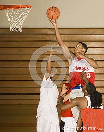 Basketball Player Dunking Basketball In Hoop