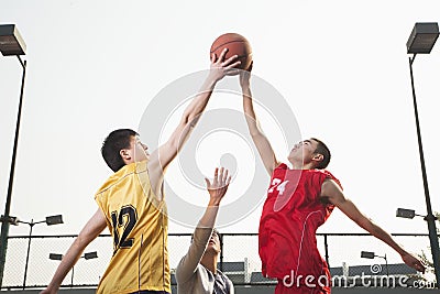Basketball players fighting for a ball