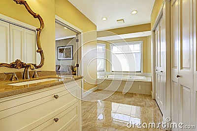 Bathroom with shiny tile floor in master bedroom