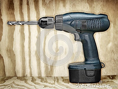 Battery power drill on plywood