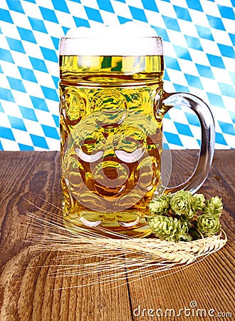 Bavarian beer, wheat and hop on wooden background