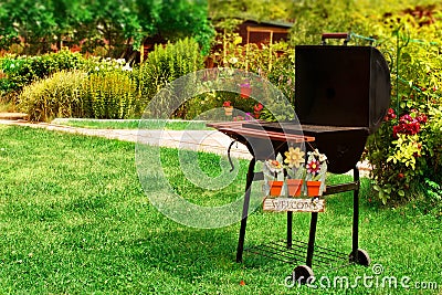 BBQ Grill and WELCOME sign in the Backyard