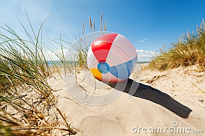 Beach ball in sand dune