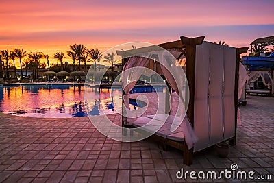 Beach bed with canopy by the pool on the beach