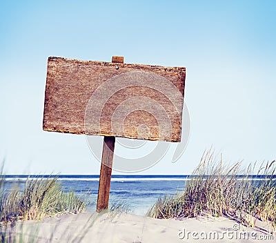 Beach with Empty Plank Sign