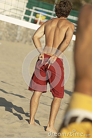 Beach volleyball player signalling team-mate