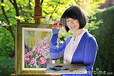 Beautiful asian girl painting outdoor