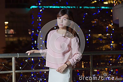 Beautiful Asian Woman with lights in Background