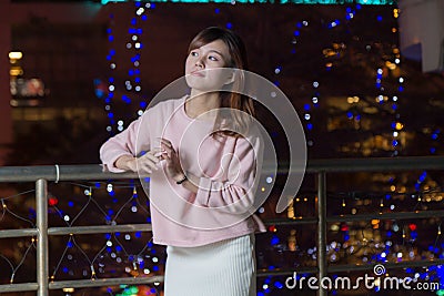 Beautiful Asian Woman with lights in Background