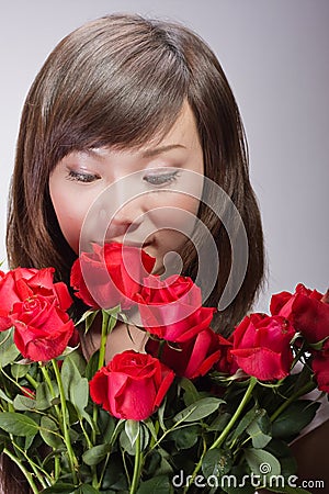 http://thumbs.dreamstime.com/x/beautiful-asian-woman-smelling-flowers-11867202.jpg