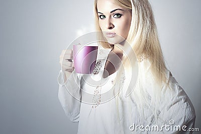 Beautiful blond woman drinking Coffee. Cup of tea