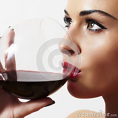 Beautiful blond woman with wineglass.red lips.dry red wine