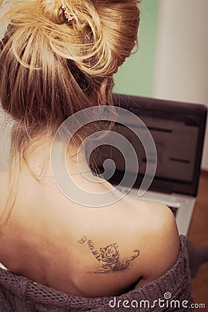 Beautiful blond young woman works on laptop pc