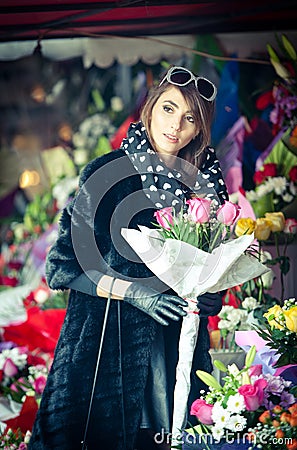 Beautiful brunette woman in black at florist shop