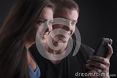 Beautiful couple with mobile phone