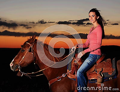 Beautiful Cowgirl on Horse in Sunset