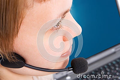 Beautiful customer support girl with laptop in headphones and microphone