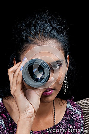 Beautiful east indian woman with camera lens