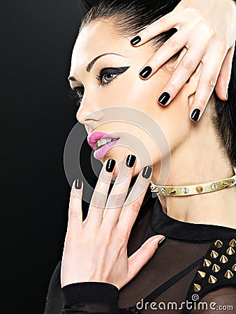 Beautiful face of fashion woman with black nails and bright make