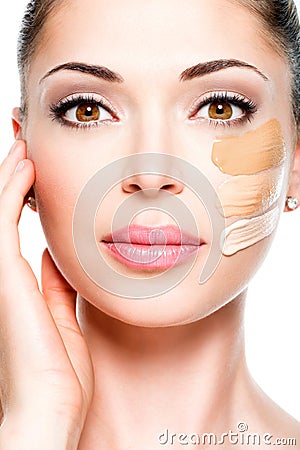 Beautiful face of woman with cosmetic foundation on a skin.