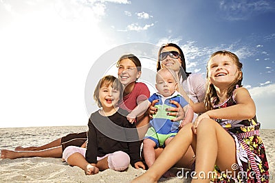 Beautiful family enjoying sunny day at the beach.