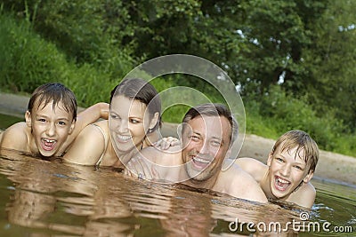 Beautiful family swims in the river