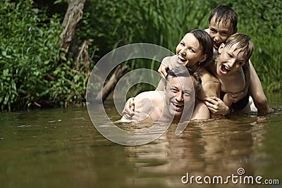 Beautiful family swims in the river