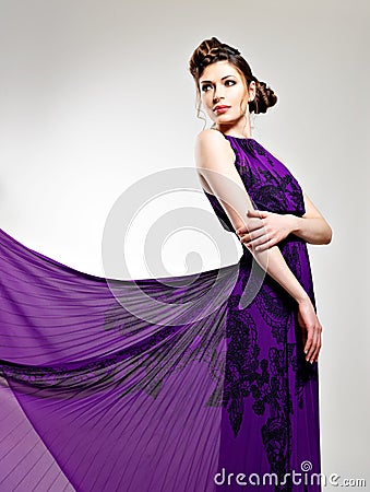 Beautiful fashion woman in violet long dress