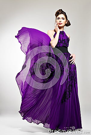 Beautiful fashion woman in violet long dress