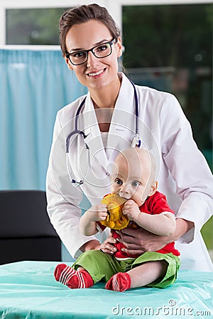 Beautiful female doctor with little baby patient