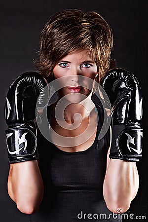 Beautiful fighter woman in boxing gloves