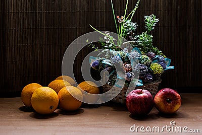Beautiful flower bouquet and fresh Oranges with apples