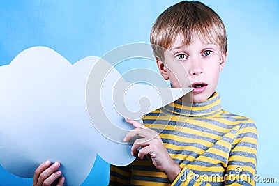 Beautiful funny blond boy holding a blank blue message cloud saying something