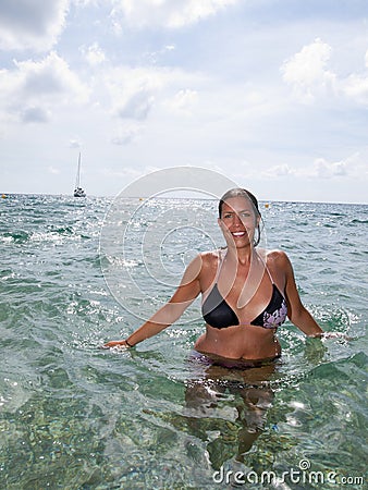 Beautiful girl in bikini in the ocean