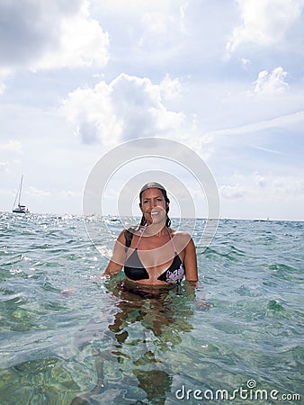 Beautiful girl in bikini in the ocean