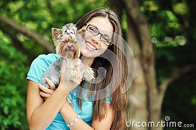 Beautiful girl hugging little dog