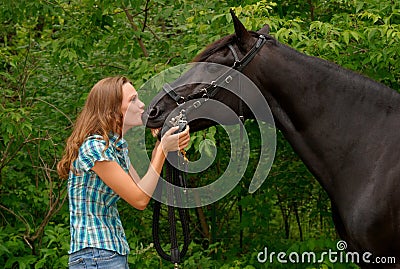 A Beautiful girl kissing her handsome horse