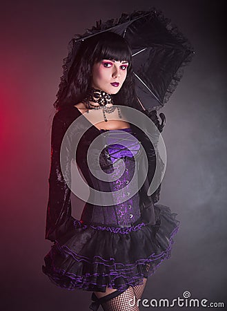 Beautiful girl in purple and black gothic outfit