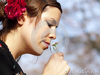 Beautiful girl smelling a cuckoo flower in the spring