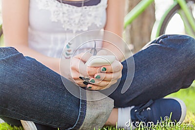 Beautiful girl using smart phone in park