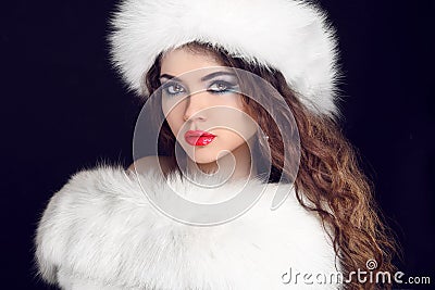 Beautiful Girl wearing in White Fur Coat and Furry Hat. Winter W