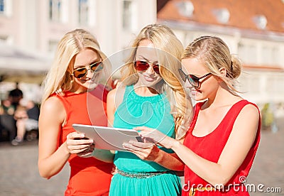 Beautiful girls toursits looking into tablet pc